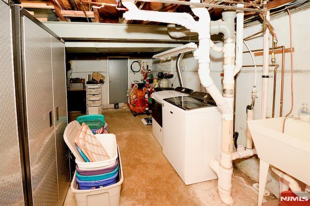 basement featuring washer and dryer and sink