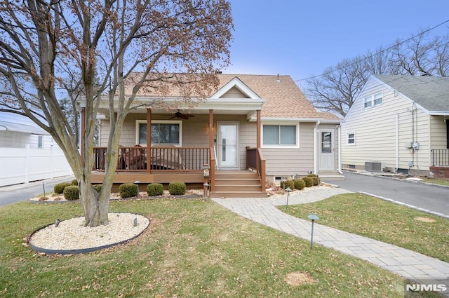 view of front of home featuring covered porch, a front lawn, and central air condition unit