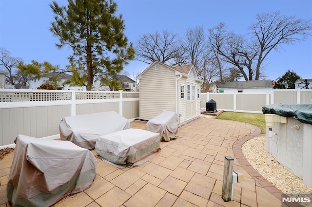 view of patio featuring a grill and an outdoor structure