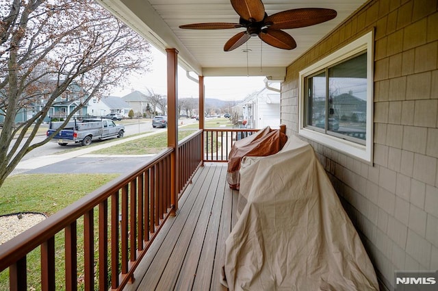 deck with covered porch and ceiling fan