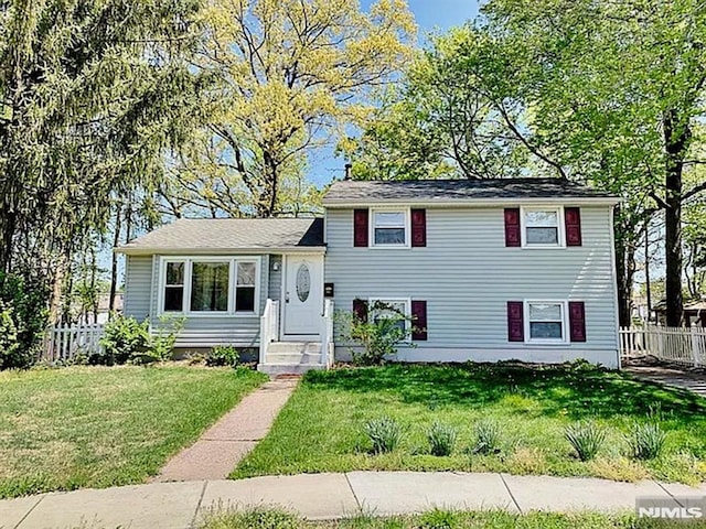 split level home with a front lawn