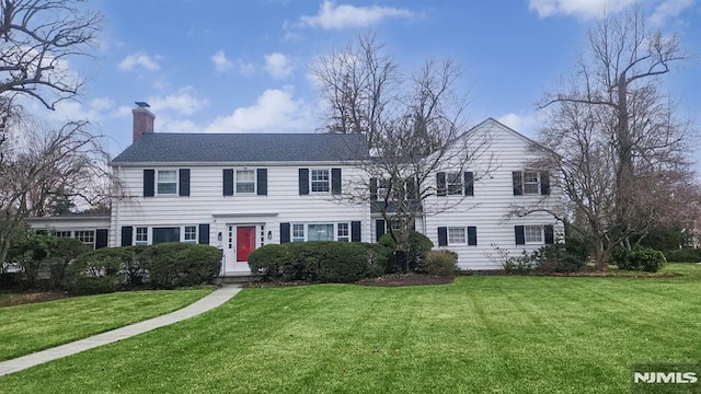 colonial inspired home with a front lawn