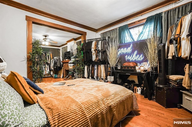 bedroom with wood-type flooring and ornamental molding