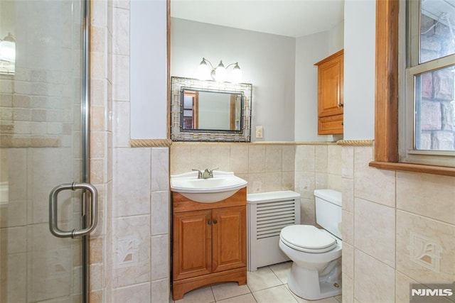 bathroom featuring tile walls, toilet, walk in shower, tile patterned floors, and vanity