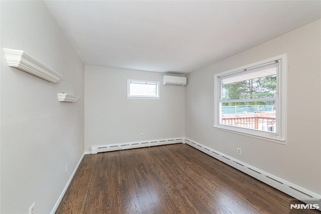 spare room with dark hardwood / wood-style floors, a wall unit AC, and a baseboard heating unit