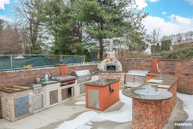 view of patio / terrace featuring area for grilling and exterior kitchen