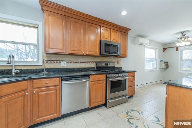 kitchen featuring stainless steel appliances, sink, ceiling fan, a baseboard heating unit, and a wall mounted AC