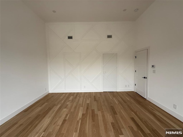 spare room featuring hardwood / wood-style flooring