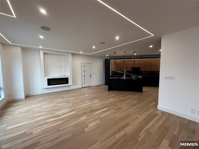 unfurnished living room with light hardwood / wood-style floors