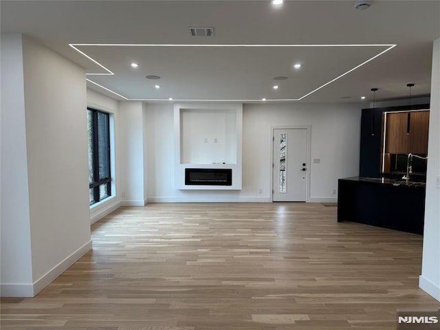 unfurnished living room featuring light hardwood / wood-style flooring