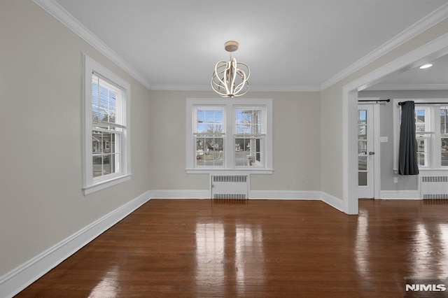 unfurnished dining area with dark hardwood / wood-style flooring, an inviting chandelier, radiator, and crown molding