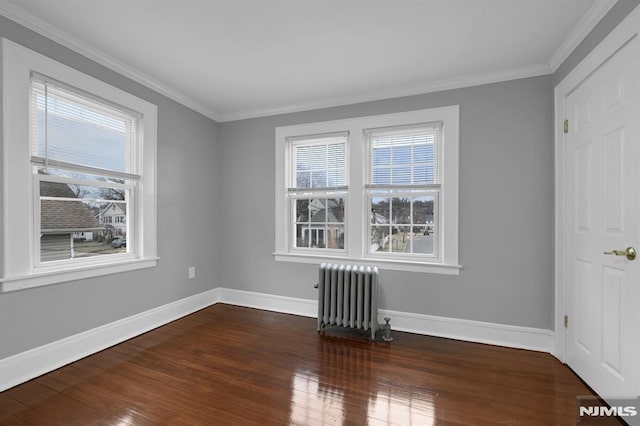 unfurnished room with radiator heating unit, dark wood-type flooring, and ornamental molding