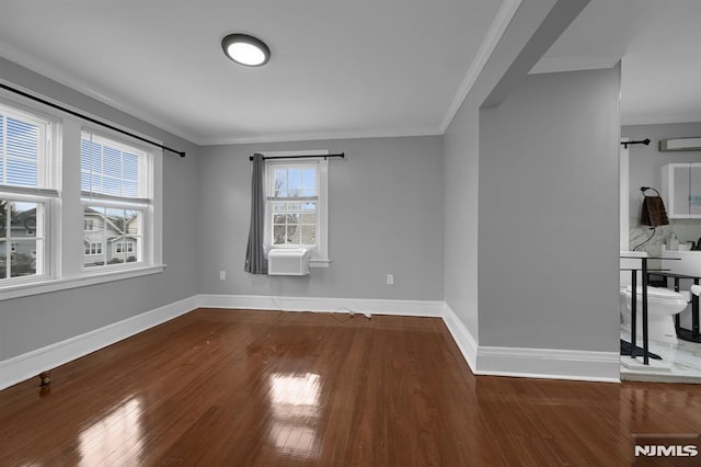 unfurnished room with hardwood / wood-style floors, cooling unit, and ornamental molding