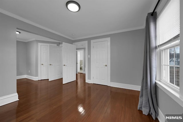 unfurnished bedroom featuring dark hardwood / wood-style flooring and ornamental molding