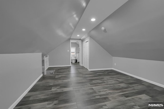 bonus room featuring dark wood-type flooring and lofted ceiling