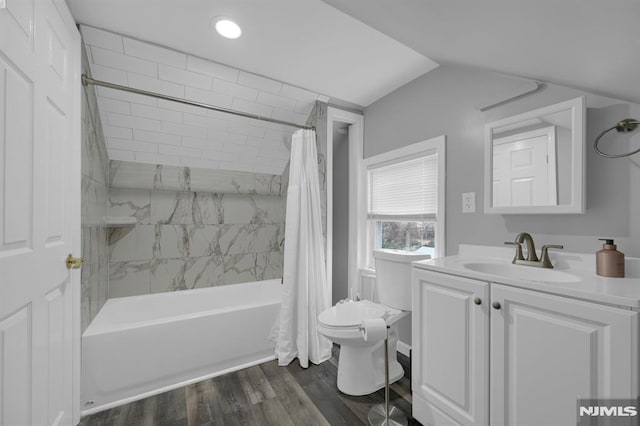 full bathroom with hardwood / wood-style floors, shower / bath combo, toilet, and vanity