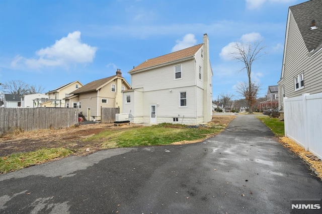 rear view of house featuring central AC unit