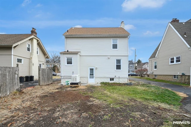 rear view of property featuring central AC unit