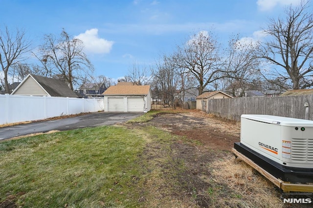 view of yard with a garage and an outdoor structure