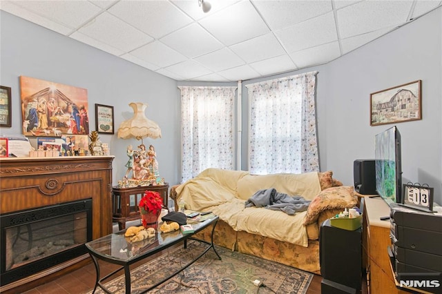 living room with a paneled ceiling