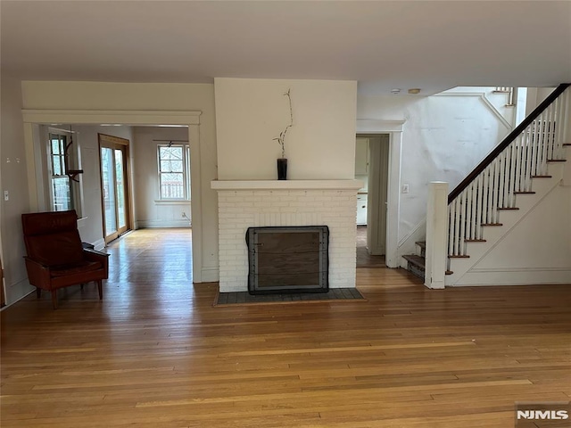 unfurnished living room featuring a fireplace and hardwood / wood-style flooring