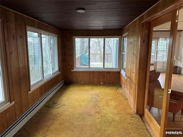 unfurnished sunroom featuring wooden ceiling and baseboard heating