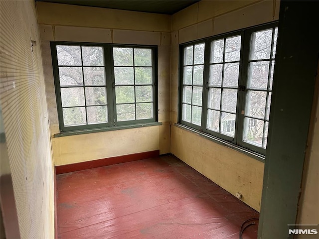 unfurnished sunroom featuring plenty of natural light