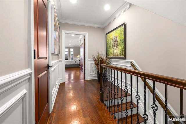 corridor with dark wood-type flooring and ornamental molding