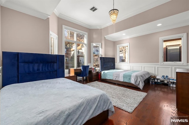 bedroom with crown molding and dark wood-type flooring