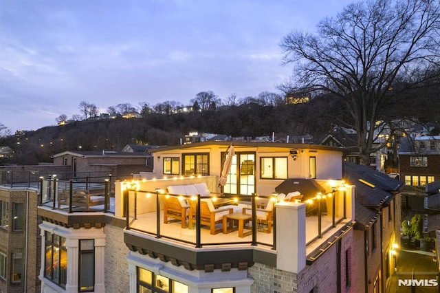 view of back house at dusk