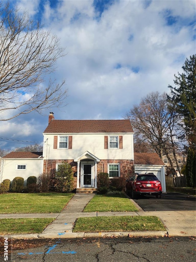 view of front of property featuring a garage and a front yard