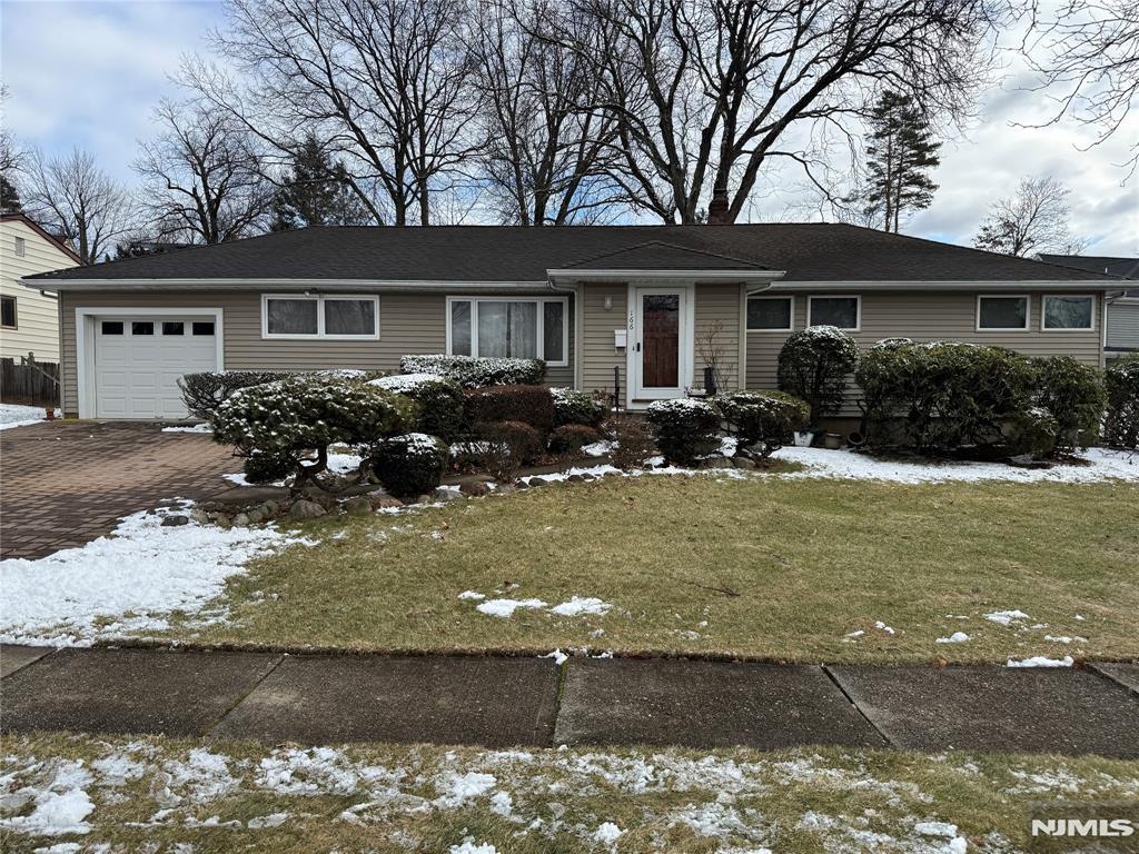 single story home with a yard and a garage