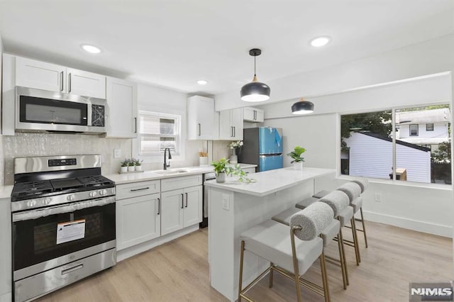 kitchen with white cabinets, sink, and appliances with stainless steel finishes