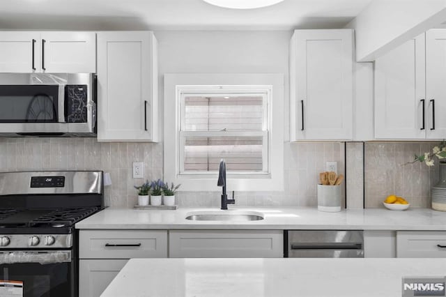 kitchen featuring sink, white cabinets, and stainless steel appliances