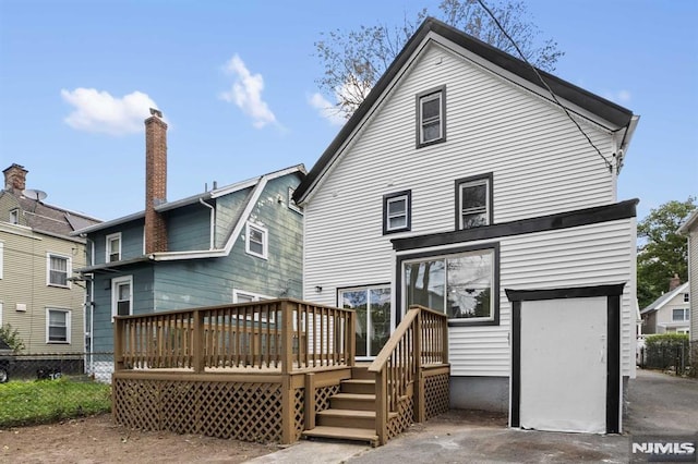 back of property with a wooden deck