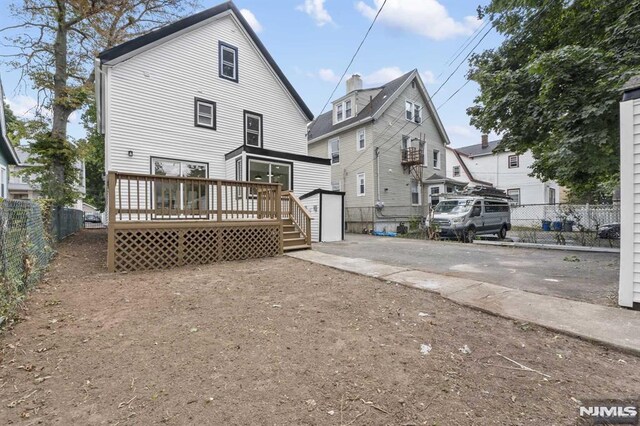 rear view of house with a wooden deck