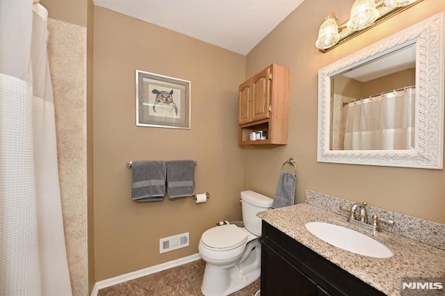 bathroom featuring toilet and vanity