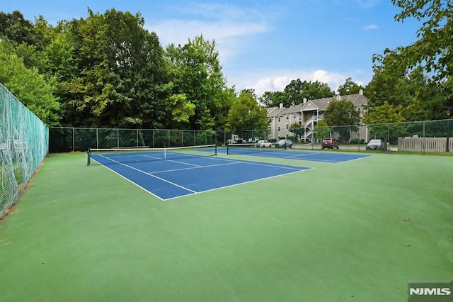 view of tennis court with basketball hoop