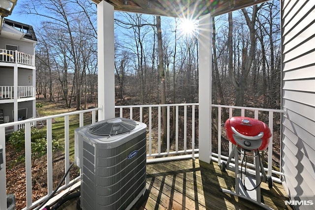 wooden terrace with grilling area and central air condition unit