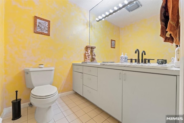 bathroom featuring vanity, tile patterned floors, and toilet