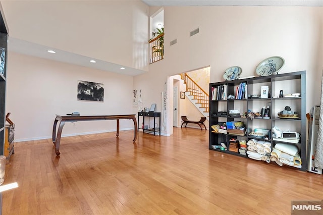 interior space featuring a high ceiling and wood-type flooring