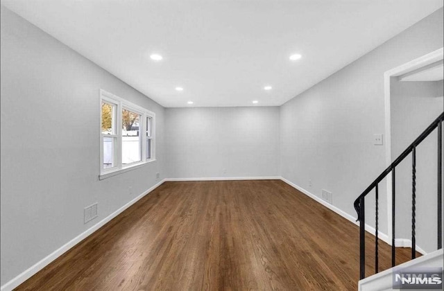 spare room featuring dark hardwood / wood-style flooring