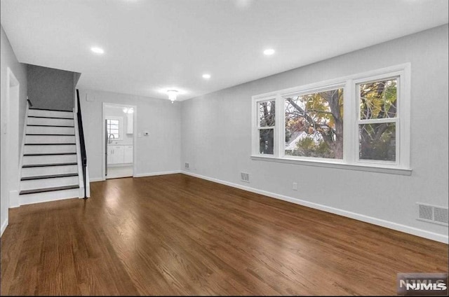 unfurnished living room with dark hardwood / wood-style flooring