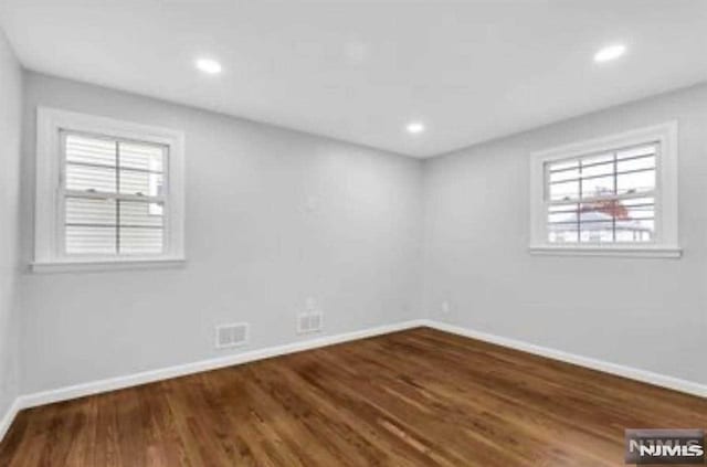 empty room with dark wood-type flooring