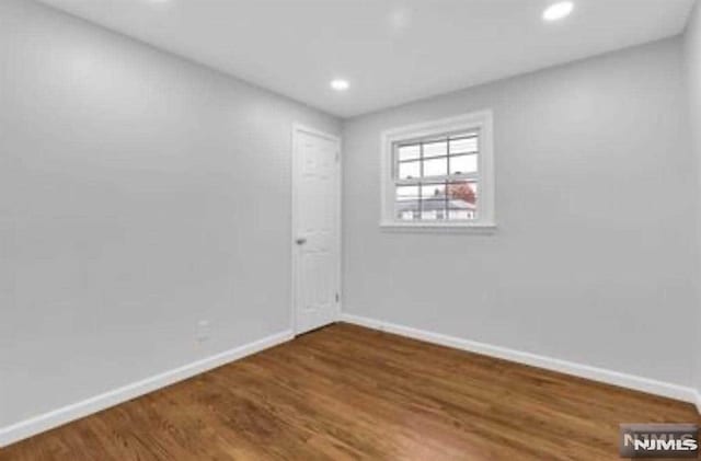 spare room featuring dark hardwood / wood-style floors