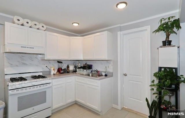 kitchen featuring white gas range oven, custom exhaust hood, sink, light tile patterned floors, and white cabinetry