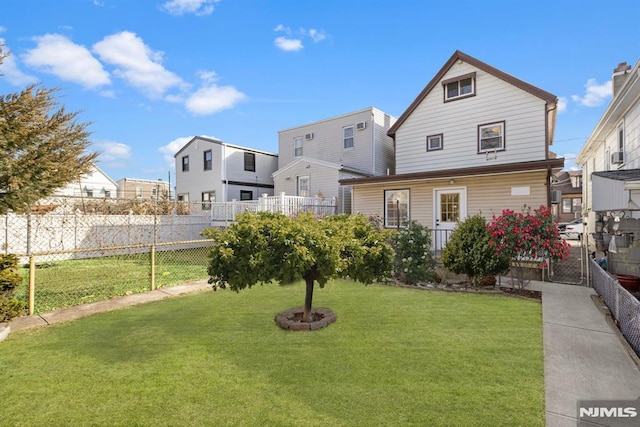 rear view of property with a yard