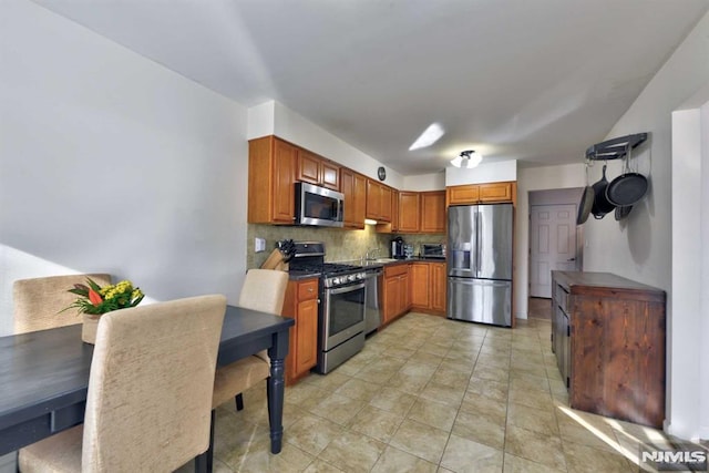 kitchen with stainless steel appliances and tasteful backsplash