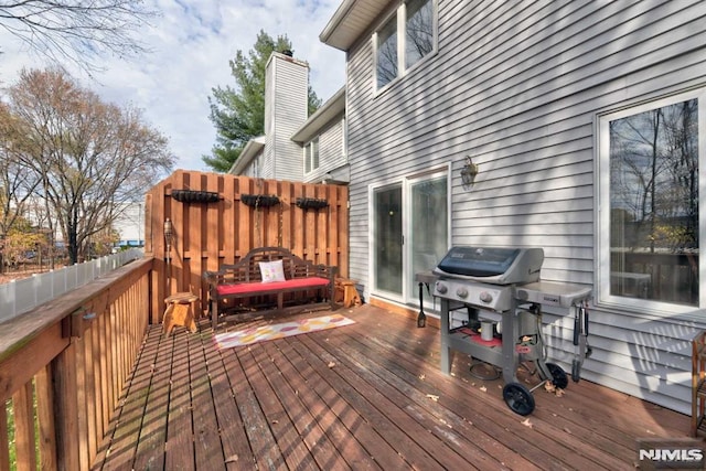 wooden terrace with a grill