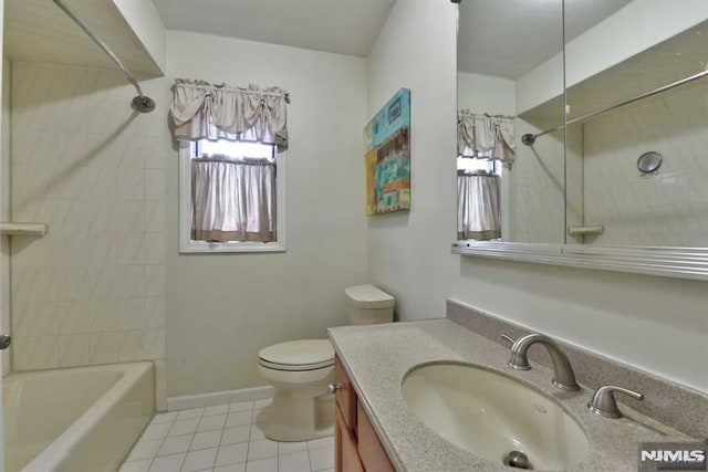 full bathroom featuring tile patterned flooring, tiled shower / bath combo, vanity, and toilet